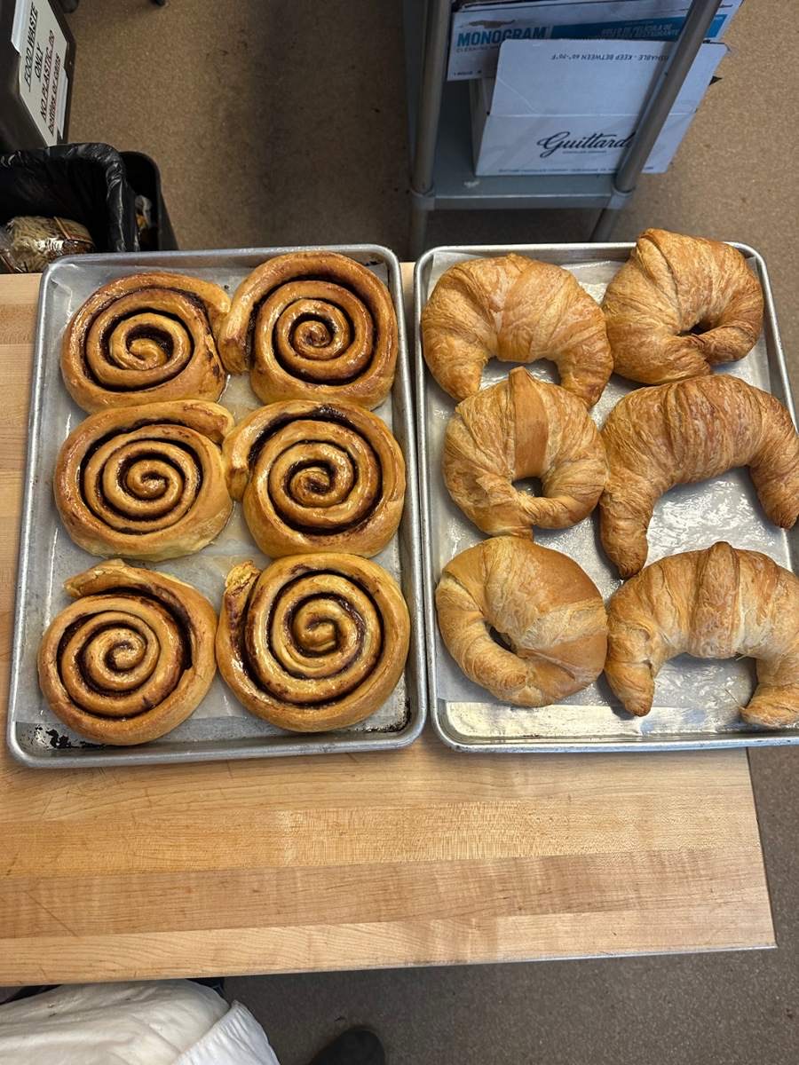 Trays of cinnamon rolls and croissants fresh from the Mercato oven