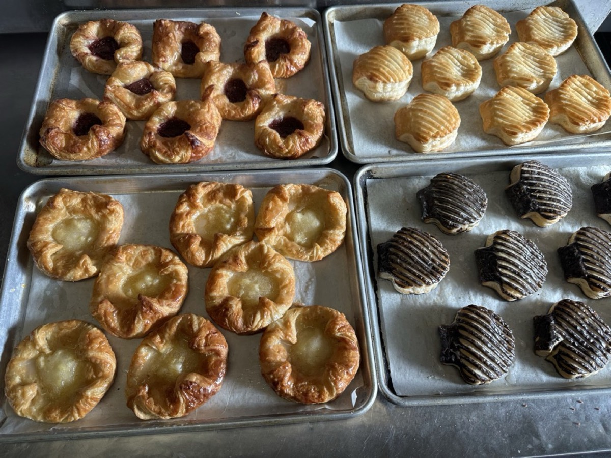 Fruit Danish and chocolate puff pastries on baking trays