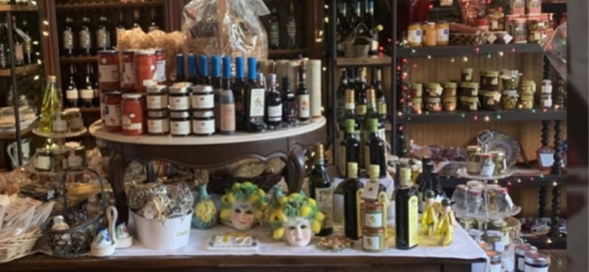 Shelves of olive oils, sauces, preserves and gift baskets